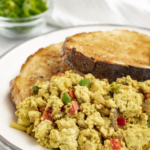 Easy tofu scramble with toast on a white plate