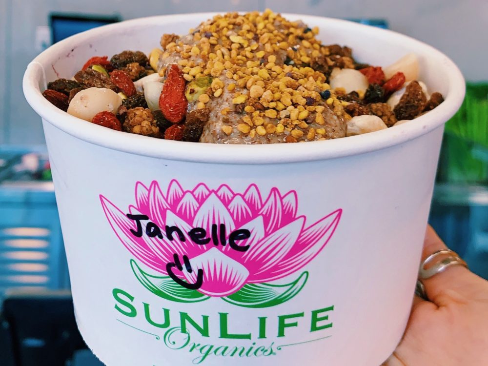 Sunlife Organics bowl topped with strawberry and bee pollen