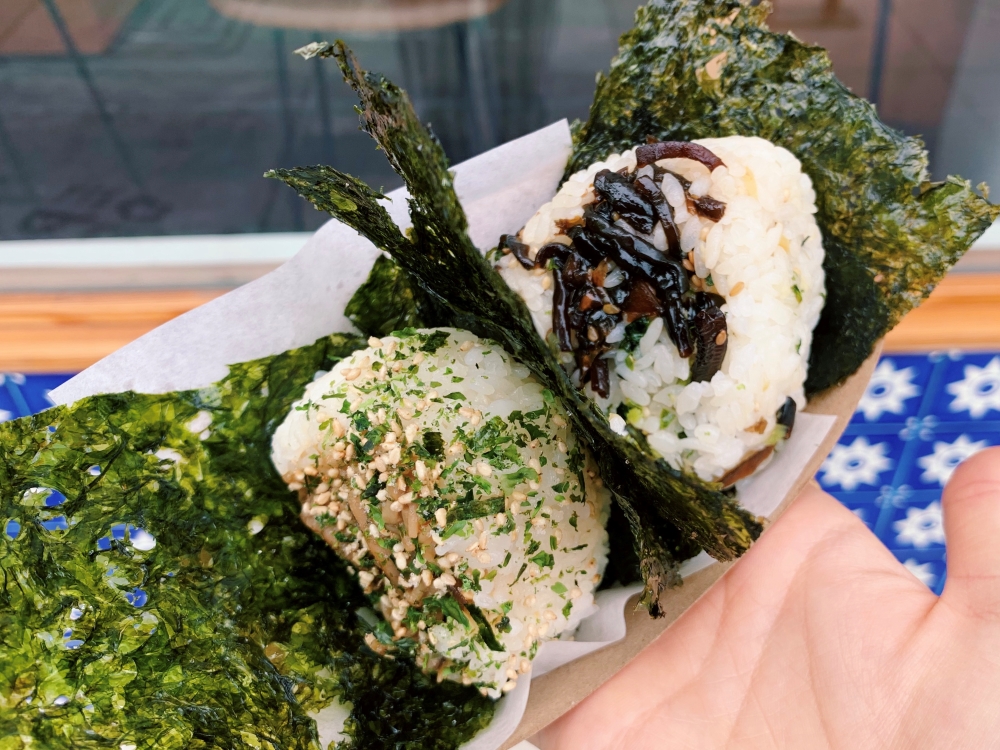 Sunny blue musubis with seaweed on a white plate
