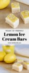 Lemon Ice Cream Bars on a wood cutting board with fresh lemons and ice cream in the background.