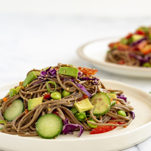 Soba Noodle salad on two white plates.